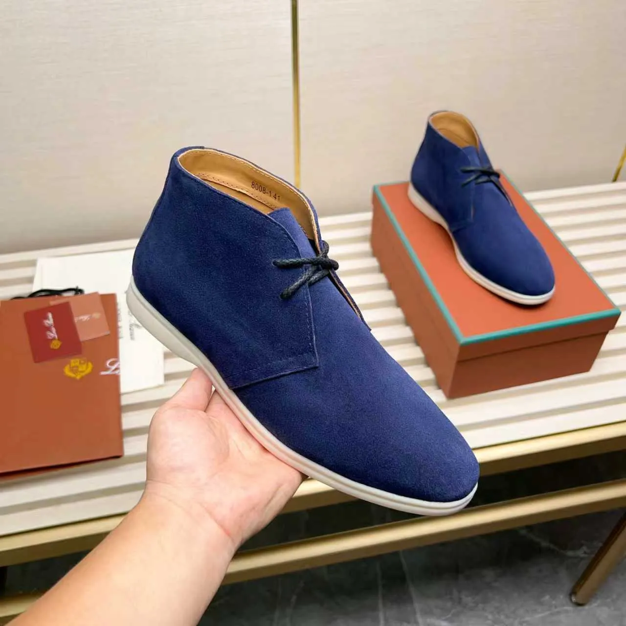Men's Shoes 💰420 Loro Piana reimagines the desert boot—a modern, comfortable interpretation of a classic 1940s style. Crafted from suede calfskin, it exudes elegance. The tight texture of suede calfskin is not only durable but also looks casual and sophisticated. Add a timeless piece to your shoe collection, harmoniously blending comfort, style and Loro Piana's heritage of craftsmanship. Acetate satin detail on the inside White sole with LP lettering for added traction Space for a personalized signature on the heel Tonal suede trim Upper: 100% cow split suede Sole: 100% Rubber lining: Cow leather